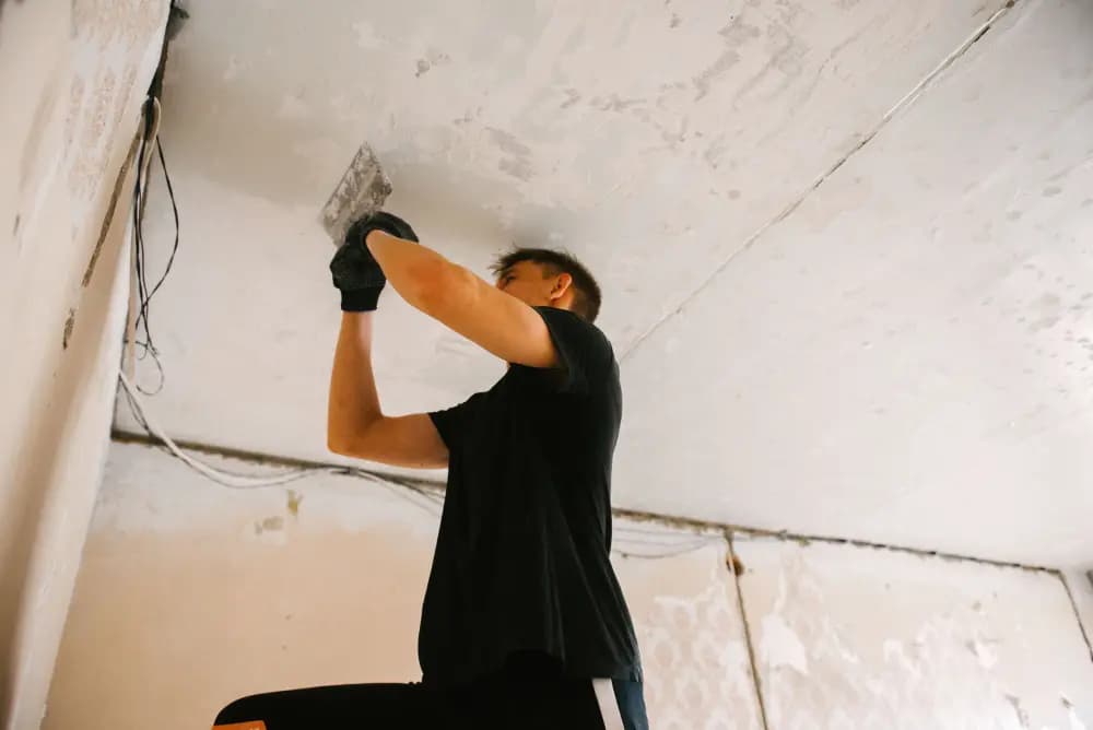 man replacing ceiling